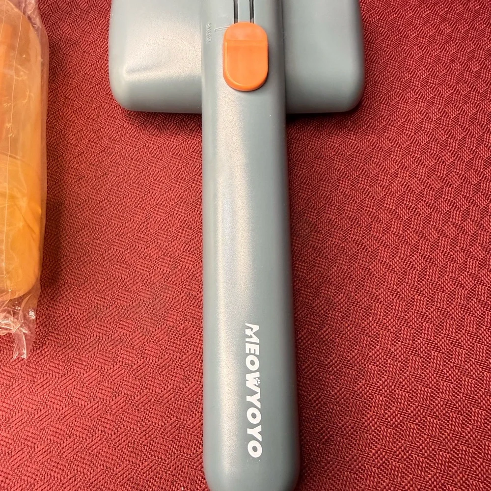 Orange and Gray Grooming Brush